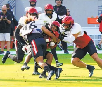  ?? NELVIN C. CEPEDA U-T ?? Aztecs receiver Jesse Matthews (45) manages to hang on to the football during the scrimmage at Snapdragon Stadium on Saturday. Matthews grabbed four catches for 64 yards.