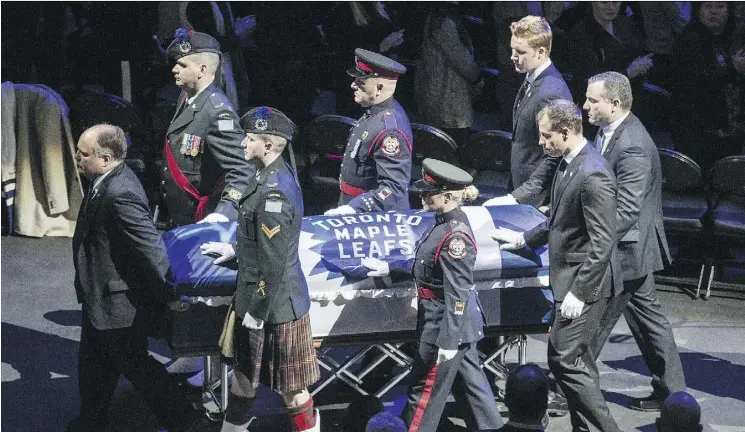  ?? PHOTOS: CRAIG ROBERTSON ?? Johnny Bower’s casket is rolled out by pallbearer­s, including Leafs goalies Frederik Andersen and Curtis McElhinney, at the Air Canada Centre on Wednesday.