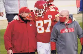  ?? Orlin Wagner / Associated Press ?? Kansas City Chiefs tight end Travis Kelce (87) walks off the field with coach Andy Reid after a game against the Cleveland Browns on Jan. 17 in Kansas City, Mo. Both Reid and Tampa Bay’s Bruce Arians are considered players’ coaches, though they do it in different ways. It's a quality that’s helped them reach the Super Bowl.