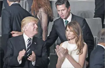  ?? Pool Photo ?? MEXICAN PRESIDENT Enrique Peña Nieto visits with President Trump and First Lady Melania Trump before a concert in Hamburg. The two leaders did not discuss the wall in their private meeting, aides said.