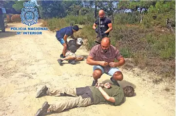  ?? — AFP photo ?? This handout picture obtained via the Spanish Police press office shows Brech (right), arrested in Spain.