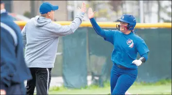  ?? KYLE TELECHAN/POST-TRIBUNE ?? Lake Central’s Jeff Sherman, the 2019 Post-Tribune Softball Coach of the Year, congratula­tes Mikayla Creasbaum after the sophomore homered during a game against Valparaiso on May 7.