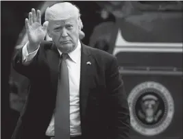  ?? ASSOCIATED PRESS ?? PRESIDENT DONALD TRUMP waves as he arrives on the South Lawn at the White House in Washington Friday.