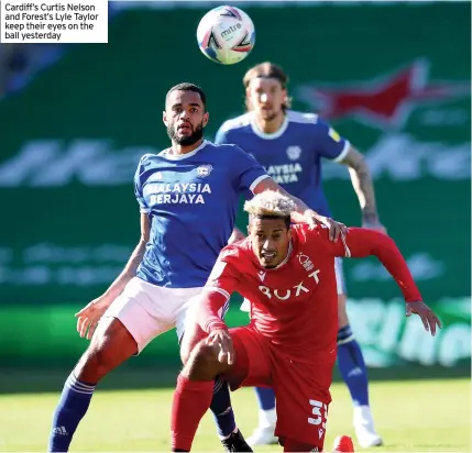  ??  ?? Cardiff’s Curtis Nelson and Forest’s Lyle Taylor keep their eyes on the ball yesterday