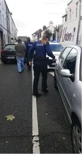  ??  ?? Gardaí lead away the theft suspects having taken them from their car.