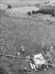  ?? THE ASSOCIATED PRESS FILE ?? An aerial photo shows the stage, foreground, and massive crowd at the Woodstock Music and Art Fair in August 1969.