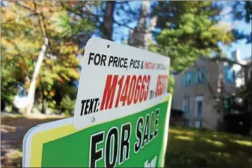  ?? FILE PHOTO BY TONY ADAMIS ?? A ‘for sale’ real estate sign sits in front of a home.