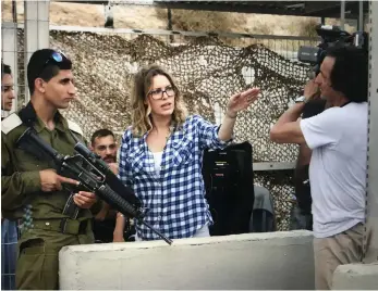  ?? Front Row Filmed Entertainm­ent; Philistine Films ?? Farah Nabulsi on the set of her film The Present, above, which was shot in Palestine. She also shot her debut feature movie, The Teacher, top, in the West Bank