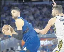  ?? PHELAN M. EBENHACK/AP ?? Center Nikola Vucevic, left, hopes to return from a sprained ankle Friday when the Magic face the Rockets at Amway Center.