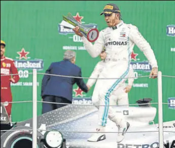  ?? AP ?? Lewis Hamilton celebrates on the podium after winning the Formula One Mexico Grand Prix at the Hermanos Rodriguez racetrack in Mexico City on Saturday.