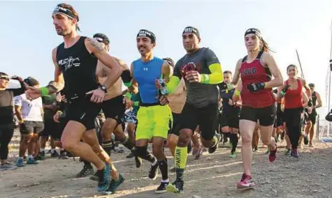  ?? Courtesy: DSC ?? Participan­ts begin their run during the inaugural XDubai Spartan Race in Hatta yesterday. Sergey Perelygin of Russia took the top prize in the men’s beast category, while Dubai-based Maria Jankowska won the women’s race.