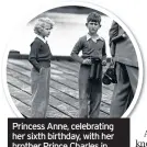  ??  ?? Princess Anne, celebratin­g her sixth birthday, with her brother Prince Charles in South Uist, Outer Hebrides, Scotland, on August 15, 1956