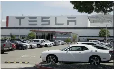  ?? BEN MARGOT — THE ASSOCIATED PRESS ?? The parking lot was nearly full at Tesla’s California electric car factory Monday, an indication that the company could be resuming production in defiance of an order from county health authoritie­s.