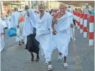  ??  ?? Muslim pilgrims walk toward the Grand Mosque to offer prayers ahead of the annual hajj pilgrimage, in Mecca, Saudi Arabia, on Saturday.