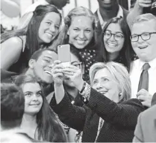  ?? JAY LAPRETE, AP ?? Hillary Clinton takes a selfie with young supporters at Fort Hayes Vocational School in Columbus, Ohio, in June.