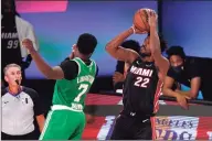  ?? Mark J. Terrill / Associated Press ?? Celtics guard Jaylen Brown (7) defends as Heat forward Jimmy Butler goes up for a shot during Wednesday’s Game 4 of the Eastern Conference finals.