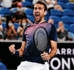 ?? Andy Brownbill / Associated Press ?? Marin Cilic of Croatia celebrates after upsetting fifth-seeded Andrey Rublev of Russia in their third-round match at the Australian Open on Saturday.