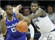  ?? LAURENCE KESTERSON — THE ASSOCIATED PRESS ?? Villanova forward Eric Paschall (4) battles for possession with Seton Hall guard Khadeen Carrington (0) during the second half of Sunday’s game in Philadelph­ia, Pa.