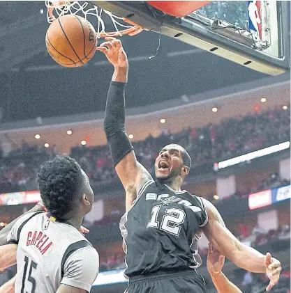  ??  ?? Spurs forward LaMarcus Aldridge dunks against the Rockets.