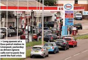  ?? ?? Long queues at a Esso petrol station in Liverpool, yesterday as drivers ignore calls not to panic buy amid the fuel crisis