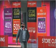  ?? FRANK AUGSTEIN / AP; JOHN SIBLEY / REUTERS ?? Sales ahead of store closures, such as this scene in Oxford Street (left), reflect the pressure on retailers as quiet London streets resulting from a third lockdown make for a bleak start to the year.