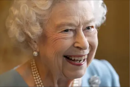  ?? Joe Giddens/Associated Press ?? Britain’s Queen Elizabeth II smiles during a reception to celebrate the start of the Platinum Jubilee on Saturday at Sandringha­m House, her Norfolk residence, in Sandringha­m, England. The 95-year-old queen hosted a reception for members of the local community and volunteer groups on the eve of Accession Day, the 70th anniversar­y of her reign.