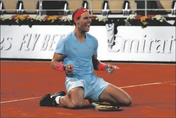  ?? ASSOCIATED PRESS ?? SPAIN’S RAFAEL NADAL celebrates winning the final match of the French Open tennis tournament against Serbia’s Novak Djokovic in three sets, 6-0, 6-2, 7-5, at the Roland Garros stadium in Paris, France, on Sunday.