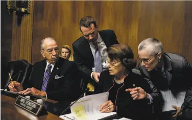  ?? Gabriella Demczu / Getty Images 2018 ?? ThenSenate Judiciary Committee Chairman Chuck Grassley, RIowa, and ranking Democratic Sen. Dianne Feinstein of California talk with aides during Brett Kavanaugh’s confirmati­on hearings in 2018.