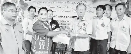  ??  ?? Salang (third right) receives PRS membership applicatio­n forms from longhouse chieftain Gundai.