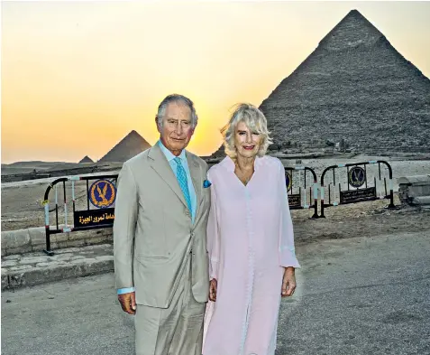  ?? ?? The Prince of Wales and the Duchess of Cornwall walked arm in arm around the Giza pyramid complex, posing for pictures with the sun going down behind them