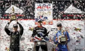  ?? MATT SLOCUM — THE ASSOCIATED PRESS ?? Second-place finisher Josef Newgarden, from left, winner Will Power and third-place finisher Alexander Rossi pose after the IndyCar auto race at Pocono Raceway, Sunday.