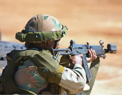  ?? Picture: Amanda Watson ?? DEADLY WEAPON. A soldier takes aim with a R4 assault rifle set up for laser tagging during an exercise at Lahotla Army Combat Training Centre in the Northern Cape.