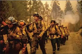  ?? Noah Berger Associated Press ?? CREWS PREPARE to battle the Dixie fire in Plumas County. Gov. Gavin Newsom said of the satellite images: “Every year, we fight to get a one-year extension.”