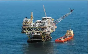  ?? — AP ?? Steady supply: A rig and supply vessel in the Gulf of Mexico, off the cost of Louisiana. A survey of industry leaders in New York concluded that most expect global oil inventorie­s to be lower over the next 12 months.