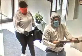  ??  ?? A video frame from a robbery May 31 at the Aurora Bank and Trust branch at 2287 West Galena Boulevard.