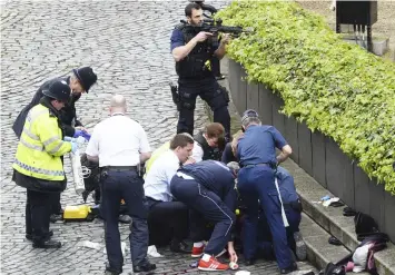  ?? (AP). ?? Emergency services at the scene outside the Palace of Westminste­r, London, Wednesday, March 22, 2017. London police say they are treating a gun and knife incident at Britain's Parliament "as a terrorist incident until we know otherwise." The...