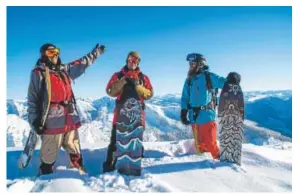  ?? Ian Provo, Warren Miller Films ?? From left, Scotty Arnold and Neil and Ian Provo navigate backcountr­y powder in British Columbia on snowboards without binding, demonstrat­ing “snowsurfin­g.”