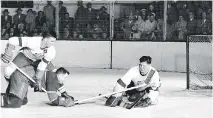  ?? DETROIT TIMES/MONTREAL GAZETTE FILES ?? Habs defenceman Doug Harvey is bulldogged to the ice by Red Wings forward Ted Lindsay in front of goalie Terry Sawchuk in a 1951 game at the Detroit Olympia.