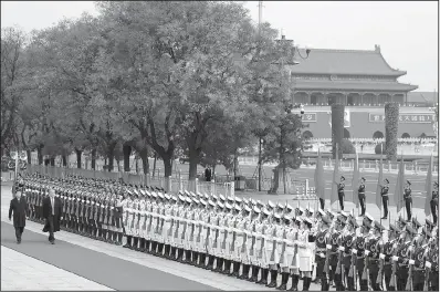  ?? AP/ANDREW HARNIK ?? President Donald Trump and Chinese President Xi Jinping review an honor guard during a welcoming ceremony today at the Great Hall of the People in Beijing.