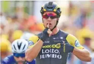  ?? THE ASSOCIATED PRESS ?? Dylan Groenewege­n celebrates as he crosses the finish line ahead of Fernando Gaviria, left, to win the seventh stage of the Tour de France on Friday in Chartres.