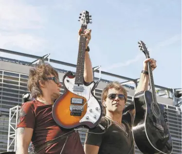  ?? MEL EVANS/AP ?? New Jersey natives Richie Sambora, left, and Jon Bon Jovi perform Oct. 22, 2009, during an invitation-only performanc­e for 5,000 fan club contest winners and constructi­on workers outside what is now MetLife Stadium in East Rutherford.