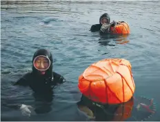  ?? (Kim Hong-Ji/Reuters) ?? JIN SO-HEE (left) and Kim Myung-soon work off the coast of Geoje, South Korea, last month.