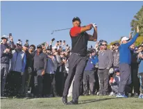  ?? RYAN KANG/THE ASSOCIATED PRESS ?? Tiger Woods hits his approach shot off the fairway on the first hole during the final round of the Genesis Invitation­al on Sunday at Riviera Country Club in the Pacific Palisades area of Los Angeles.