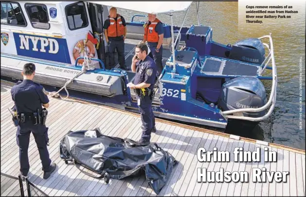  ??  ?? Cops remove remains of an unidentifi­ed man from Hudson River near Battery Park on Thursday.