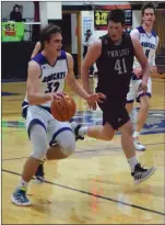  ?? Alex Eller photos unless noted ?? 5. Drew Vickers of South Loup dribbles down the lane as Quade Young of Twin Loup trails him in the teams matchup on Dec. 4. The Bobcats pulled out the victory by a final of 50-21. Loleta Connell