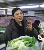  ??  ?? Zhao Xingqi from Anhui Province has been selling vegetables since 1999.