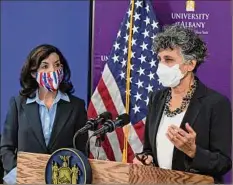  ?? Will Waldron / Times Union ?? Gov. Kathy Hochul, left, listens, as acting state Commission­er of Health Dr. Mary T. Bassett says the state has not establishe­d a cut point for metrics, mainly because it is using all of them together.