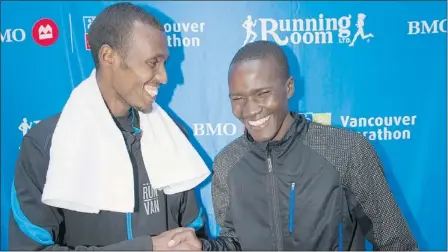  ?? WARD PERRIN — PNG PHOTOS ?? Vancouver Marathon winner Gezahgn Eshetu (left) is congratula­ted by second-place finisher Benard Onsare after Sunday’s race. Eshetu won with a time of 2:21:51; Onsare ran 2:22:16.