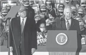  ??  ?? Sen. Ron Johnson, R-Wis., speaks as President Donald Trump looks on at the Oct. 17 campaign appearance in Janesville.