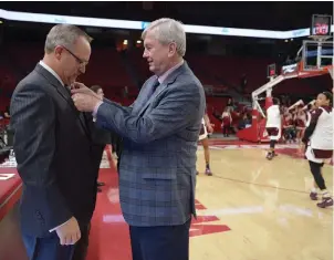  ?? NWA Democrat-Gazette/Andy Shupe ?? Texas A&M coach Gary Blair, right, straighten­s the tie of Arkansas coach Mike Neighbors before their Feb. 22, 2018, game in Bud Walton Arena.